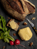 ploughgate creamery cultured butter on a board with radishes and bread - buy artisan butter online